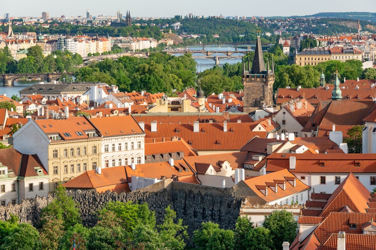 Panoramic view of Prague old town with historic red-roof buildings and Vltava River