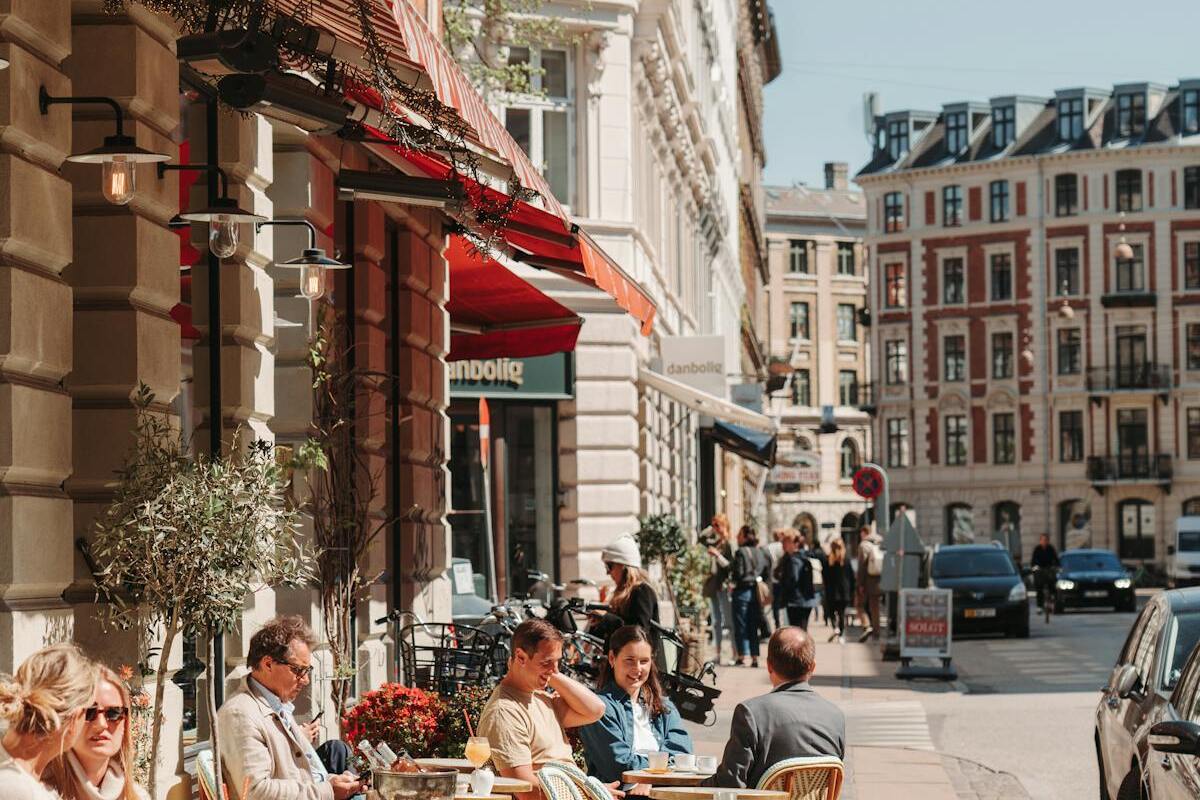 People enjoying outdoor street cafes in a European city — a typical scene in Germany's urban expat neighborhoods
