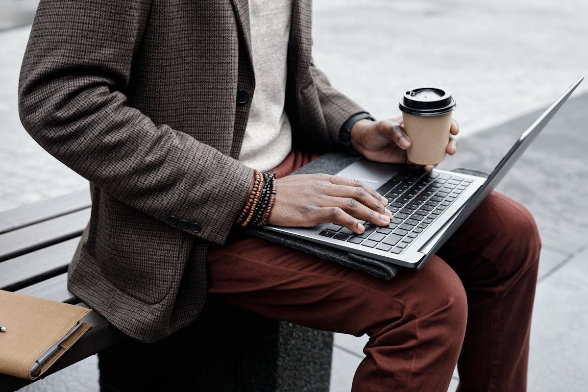 Remote worker reviewing finances on laptop at cafe while living abroad as expat