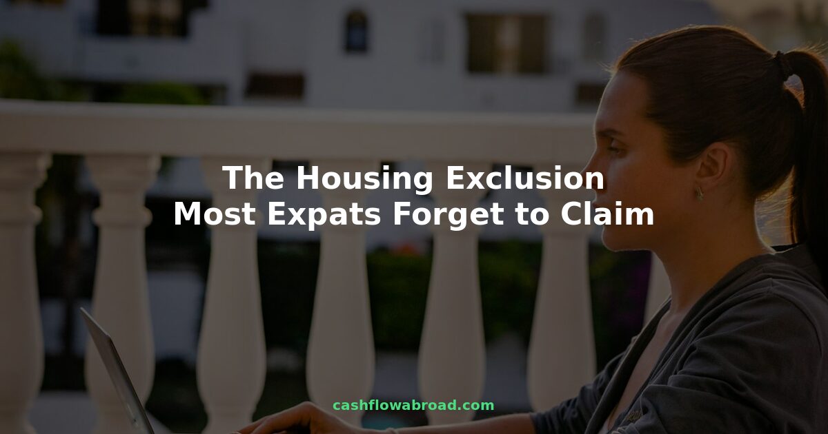 US expat working abroad on laptop with housing exclusion tax guide