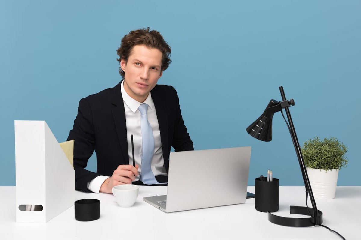 Business professional working at laptop representing an AI chatbot agency owner managing client accounts remotely