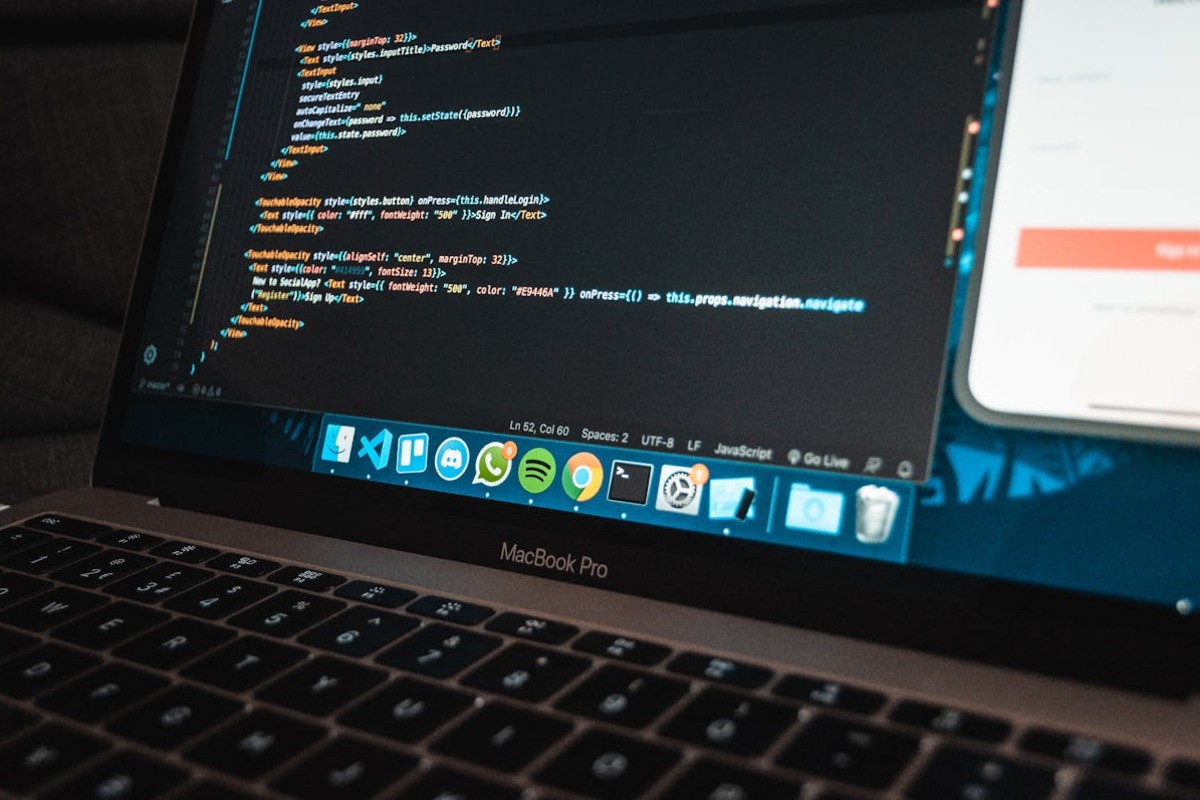 Developer working on laptop with code editor — the typical remote setup for an AI freelancer working from abroad