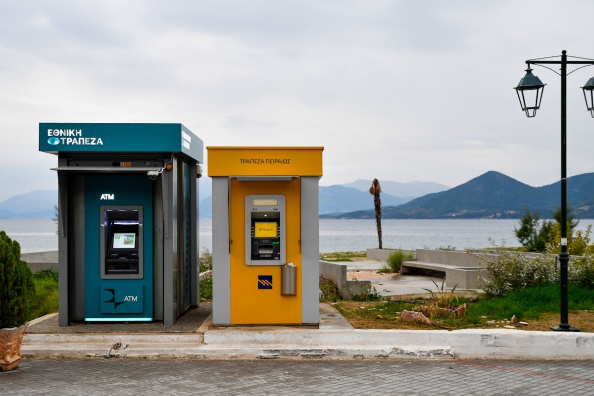 ATMs along a scenic Mediterranean coastal street - using your Schwab card abroad fee-free