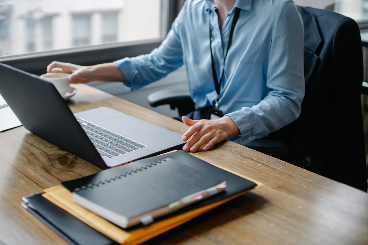 Digital nomad working on laptop with coffee in a cafe abroad, building an AI affiliate site