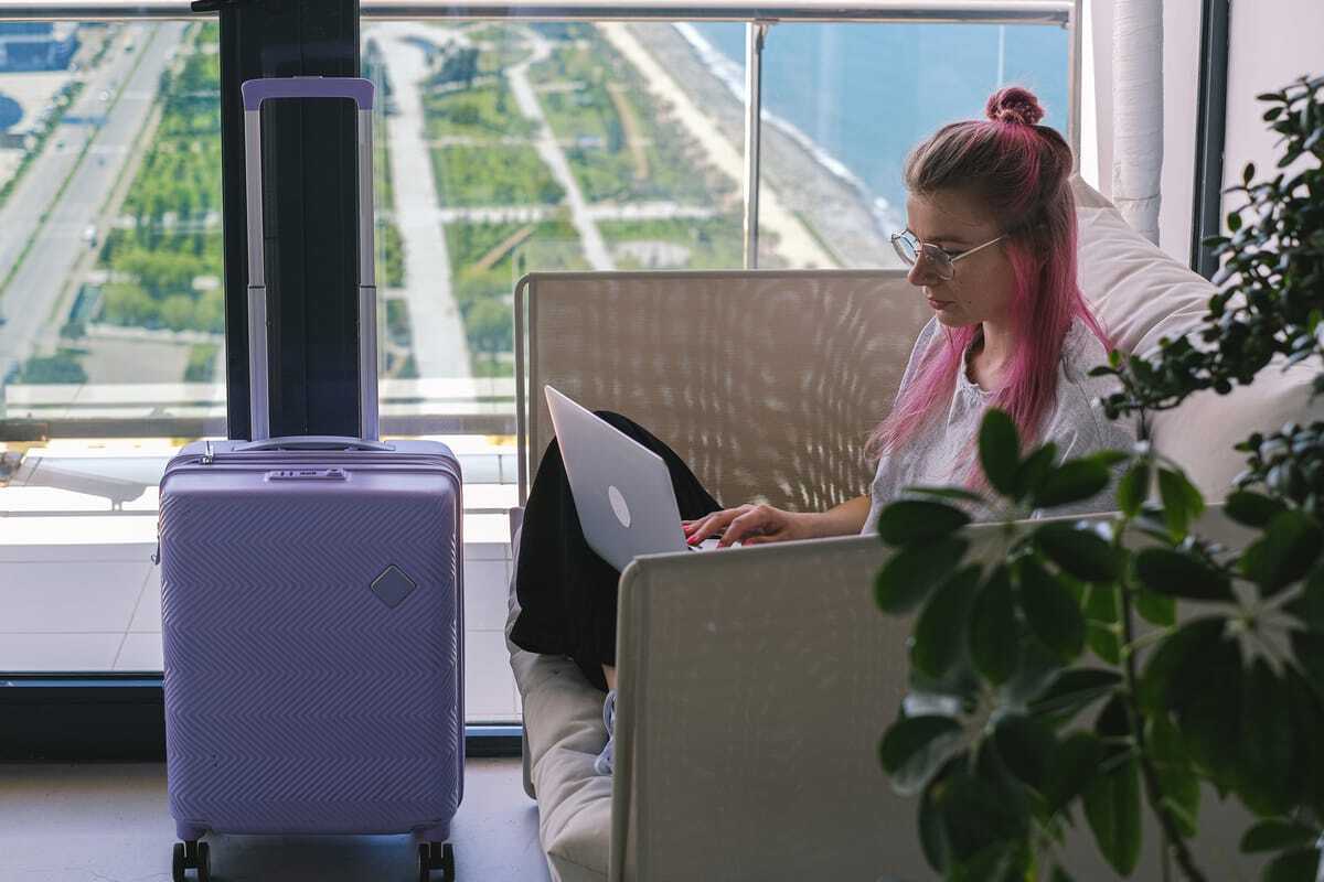 Digital nomad working on laptop abroad — AI consulting from a low-cost country