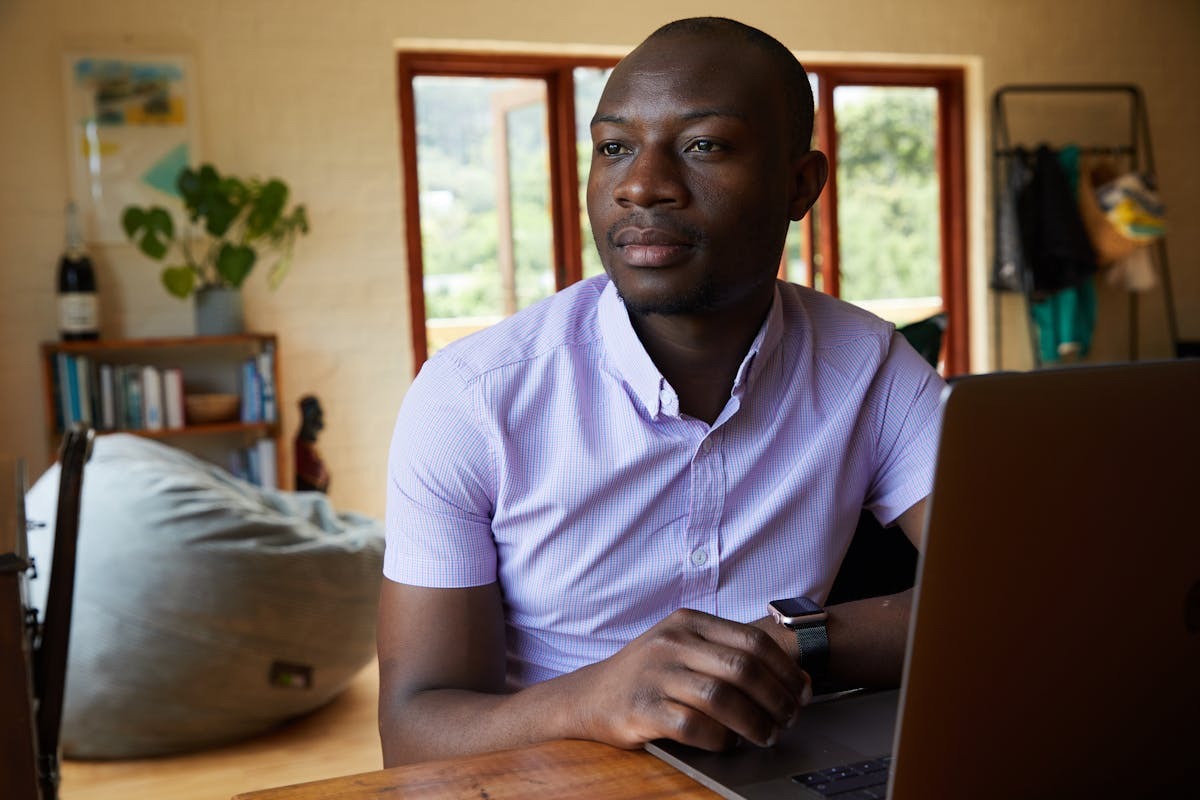 US expat entrepreneur working on laptop abroad managing foreign company tax obligations