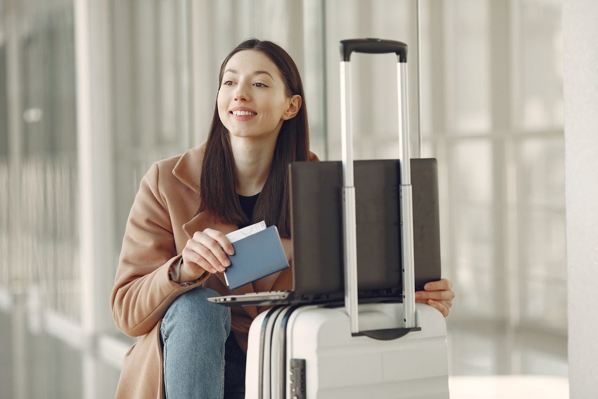 US expat with passport and laptop managing foreign financial accounts while traveling