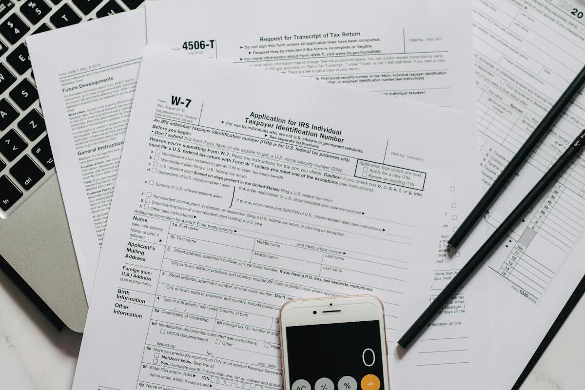 IRS tax documents and W-7 form on a desk representing expat tax filing requirements