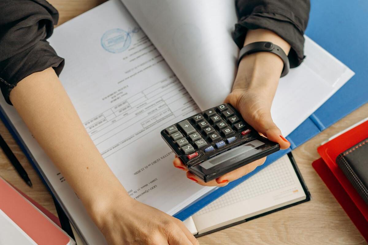 Person reviewing financial documents and retirement account planning at desk
