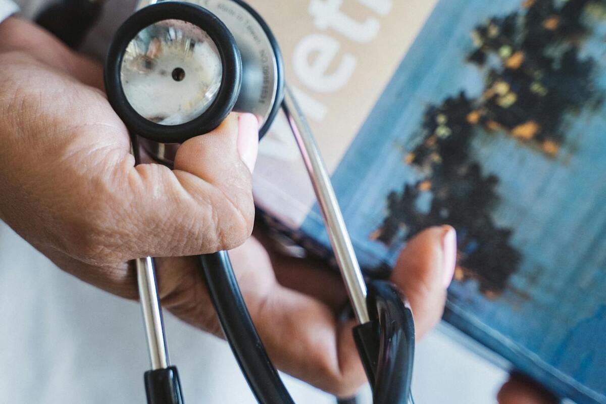 Stethoscope alongside a travel guide representing healthcare navigation for US expats abroad