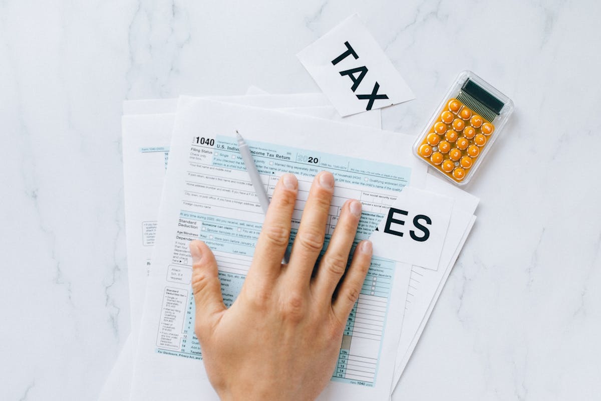 Person reviewing IRS tax documents at a desk, representing the consequences of seriously delinquent tax debt for Americans abroad