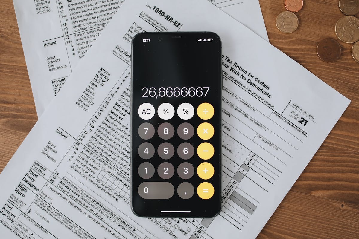 Tax forms and financial documents reviewed by a US expat freelancer for self-employment tax filing