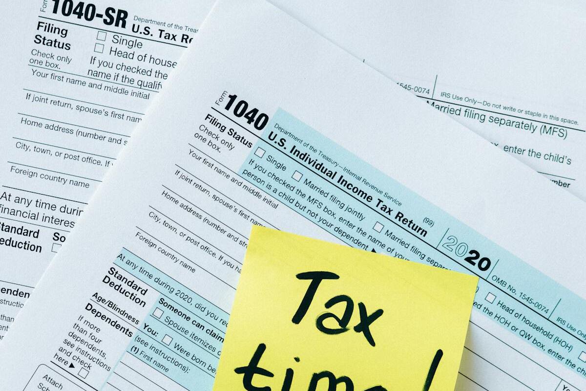 Tax documents spread on a table representing FBAR and FATCA filing requirements for US expats abroad