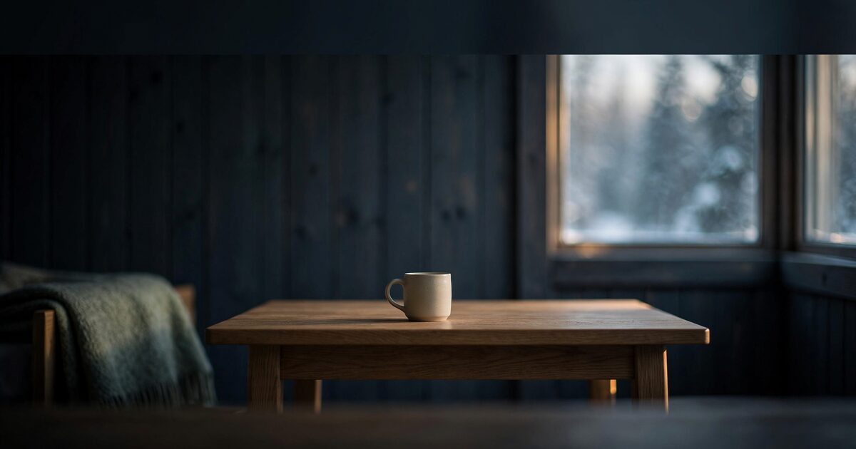 Sunlit Scandinavian apartment table with ceramic mug and wool throw