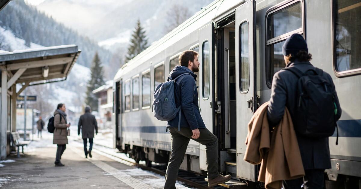 Traveler with a backpack boarding a mountain train in hard morning light