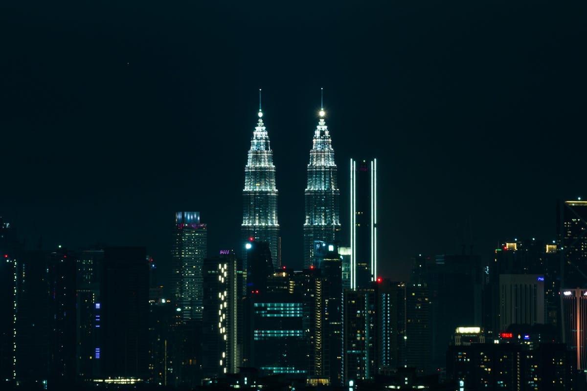Illuminated Petronas Towers at night in Kuala Lumpur, Malaysia