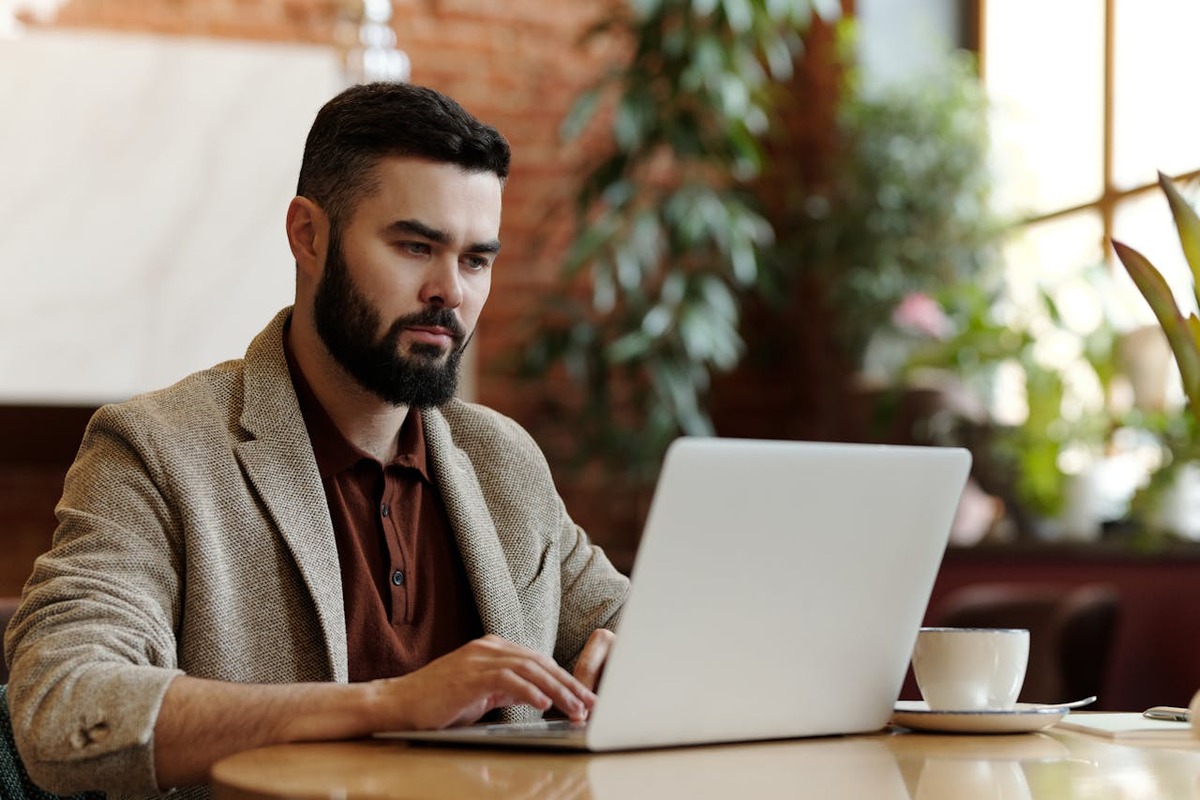 Expat professional working remotely on a laptop in a European café